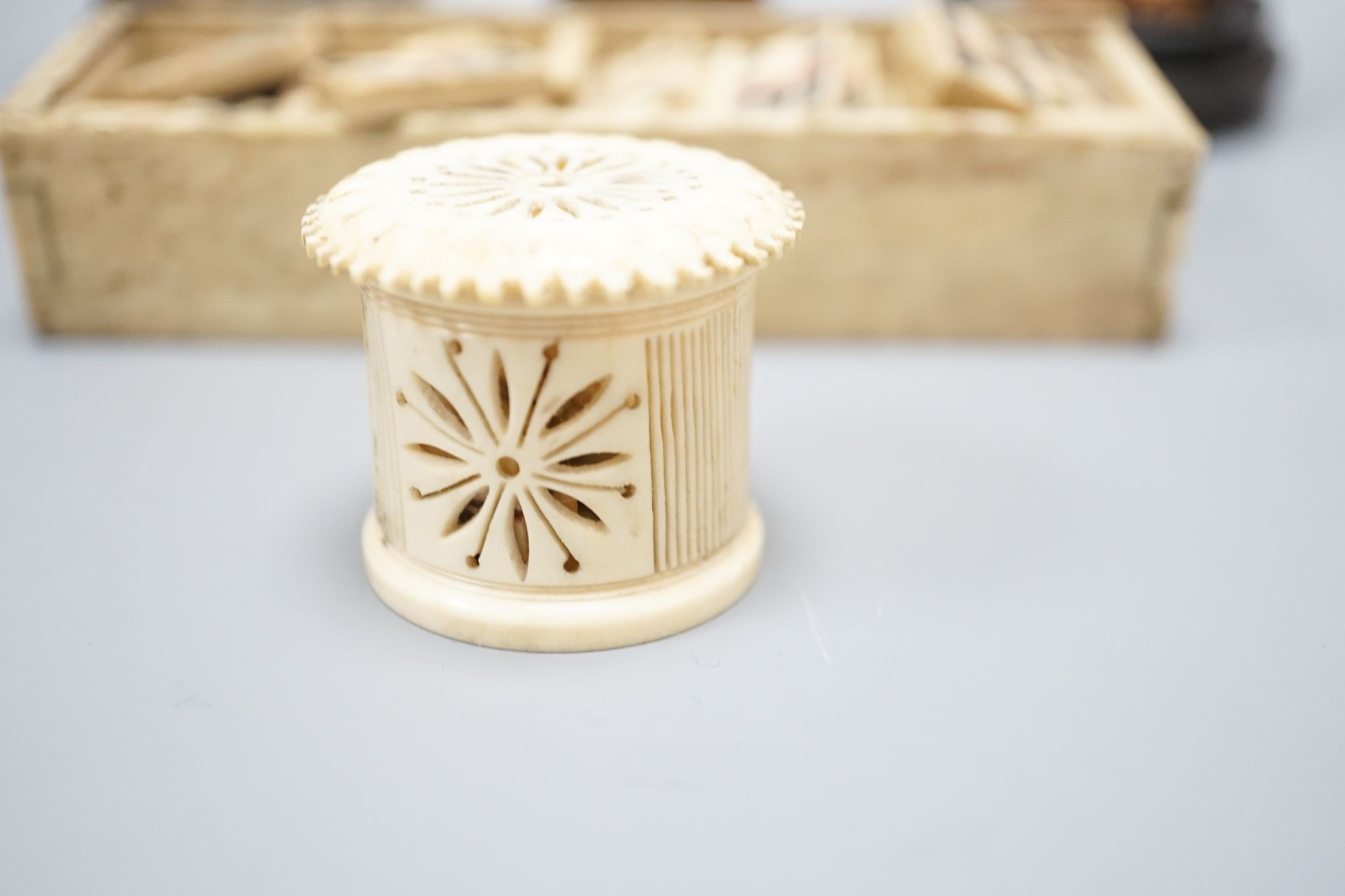 Three Chinese carved hippo tooth figures of Immortals, a 19th-century bone boxed dominoes set and a 19th-century ivory case set of dominoes